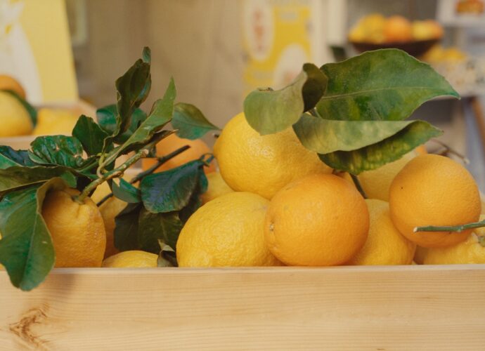 a wooden box filled with lots of oranges